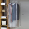 A display of transparent zippered clothes storage bags hanging on a rod against a light gray wall.