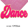 Pink glitter embroidered patch spelling the word Dance on a pink grid background