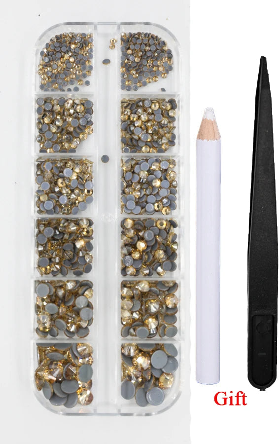 A clear plastic container holds various sizes and colors of crystal hot fix rhinestones and an applicator tool.