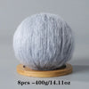 A spherical ball of gray mohair yarn used for crafting.