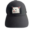 Black baseball cap with an embroidered patch featuring a stylized cat face.