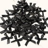 A pile of small black satin ribbon bows for crafts and decor.