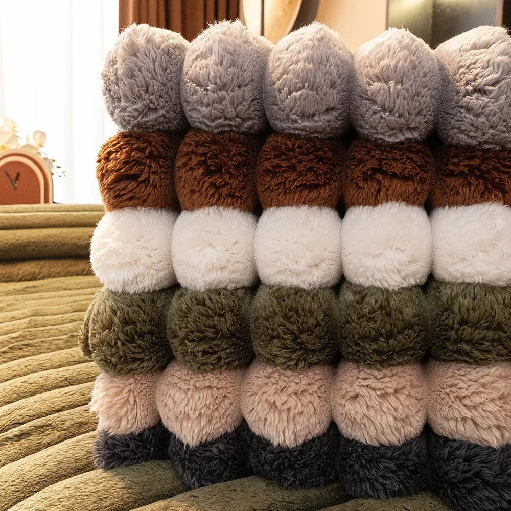 A row of thick, fluffy sofa seat cushions in various shades of brown, beige, and gray.