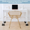 A gold-colored wire chair is placed at a white desk, illustrating the relief of sitting stress caused by low furniture height