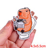 An orange cartoon bear holding a newspaper embroidered iron-on patch on a hand.