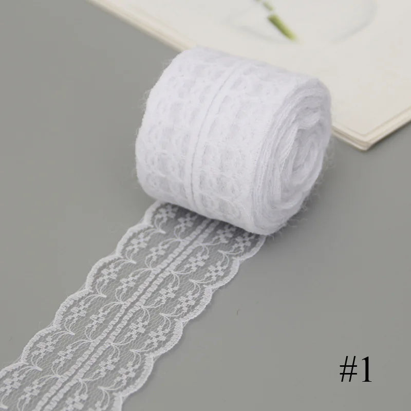 A roll of white cotton lace ribbon with floral patterns is shown next to a rolled white fabric strip.