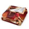 A vintage football knit throw blanket in shades of red and orange with a white lining.
