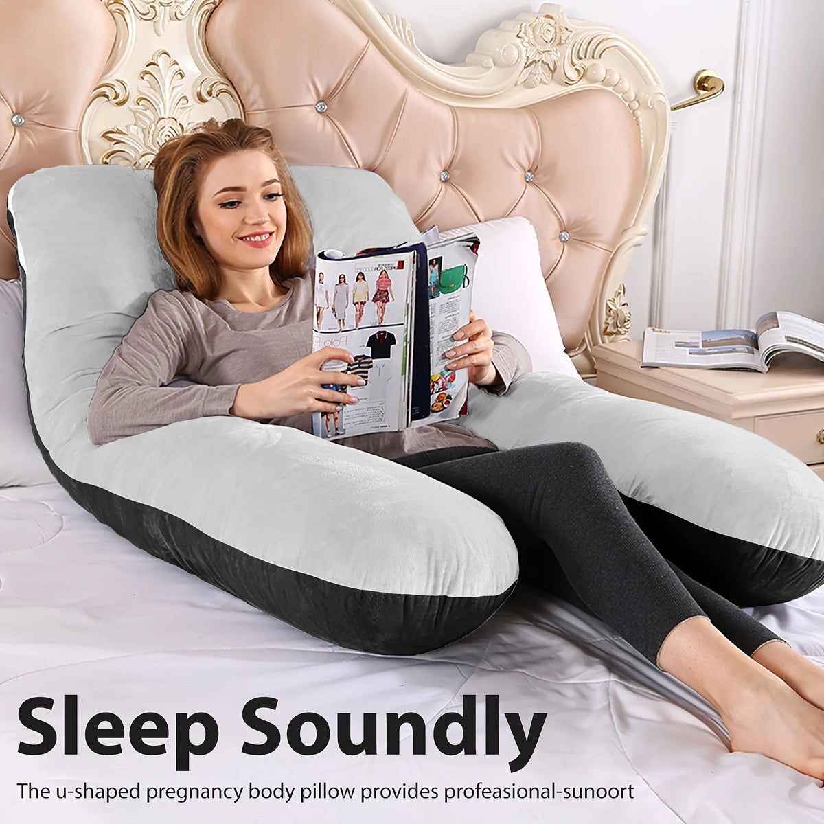 A woman relaxing in a beige U-shaped body pillow on a bed, reading a magazine.
