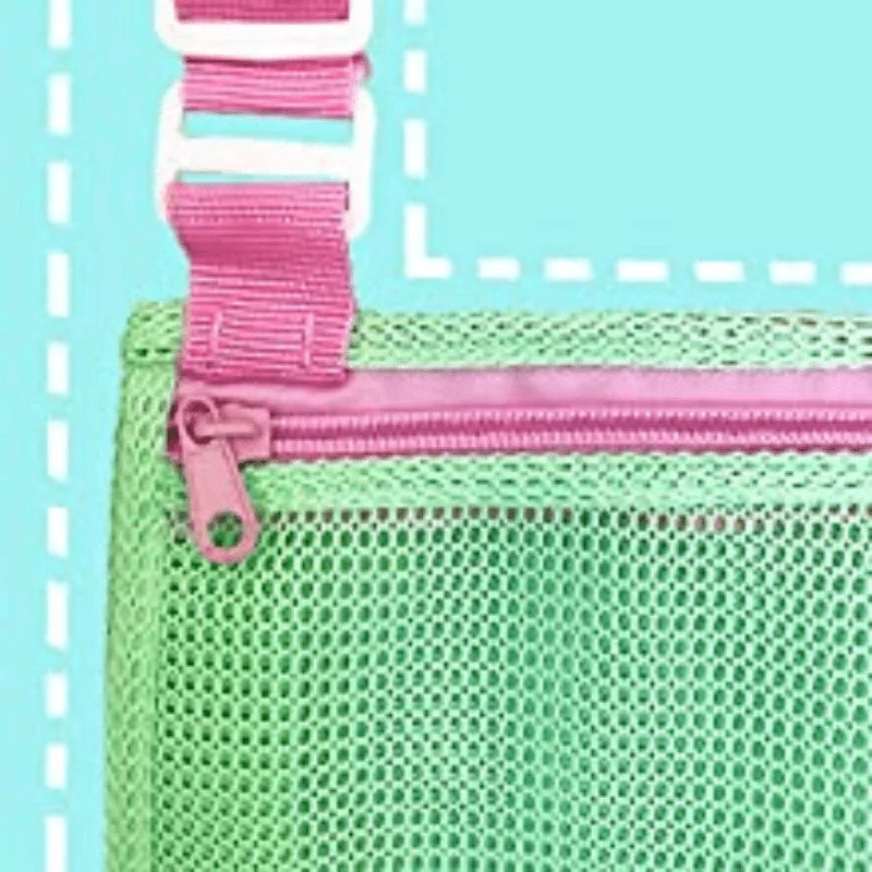 A close-up of a lime green mesh beach bag with pink and white straps and a zipper.