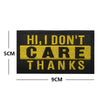 Black embroidered alphabet hook and loop patch with yellow text saying HI I DON'T CARE THANKS