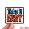 A square embroidered patch with the text Take it EASY in blue and orange thread.
