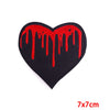 A black heart shaped embroidery patch with a dripping red paint effect.