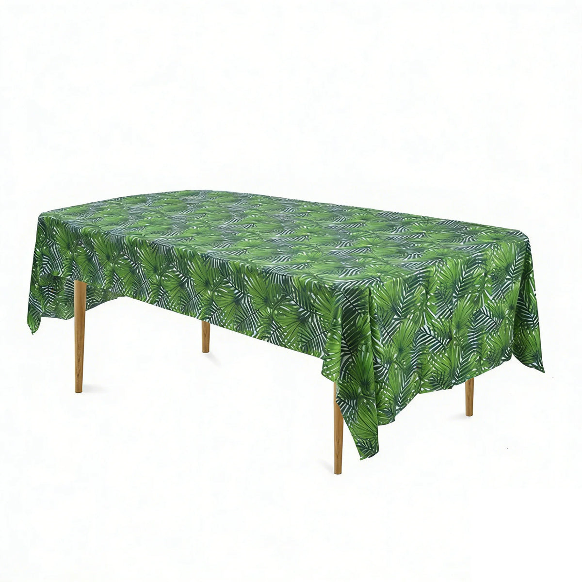 A green cow print disposable plastic tablecloth spread over a wooden table.