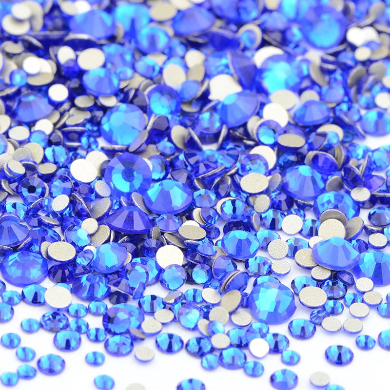 A pile of blue and silver glass rhinestones for DIY crafts