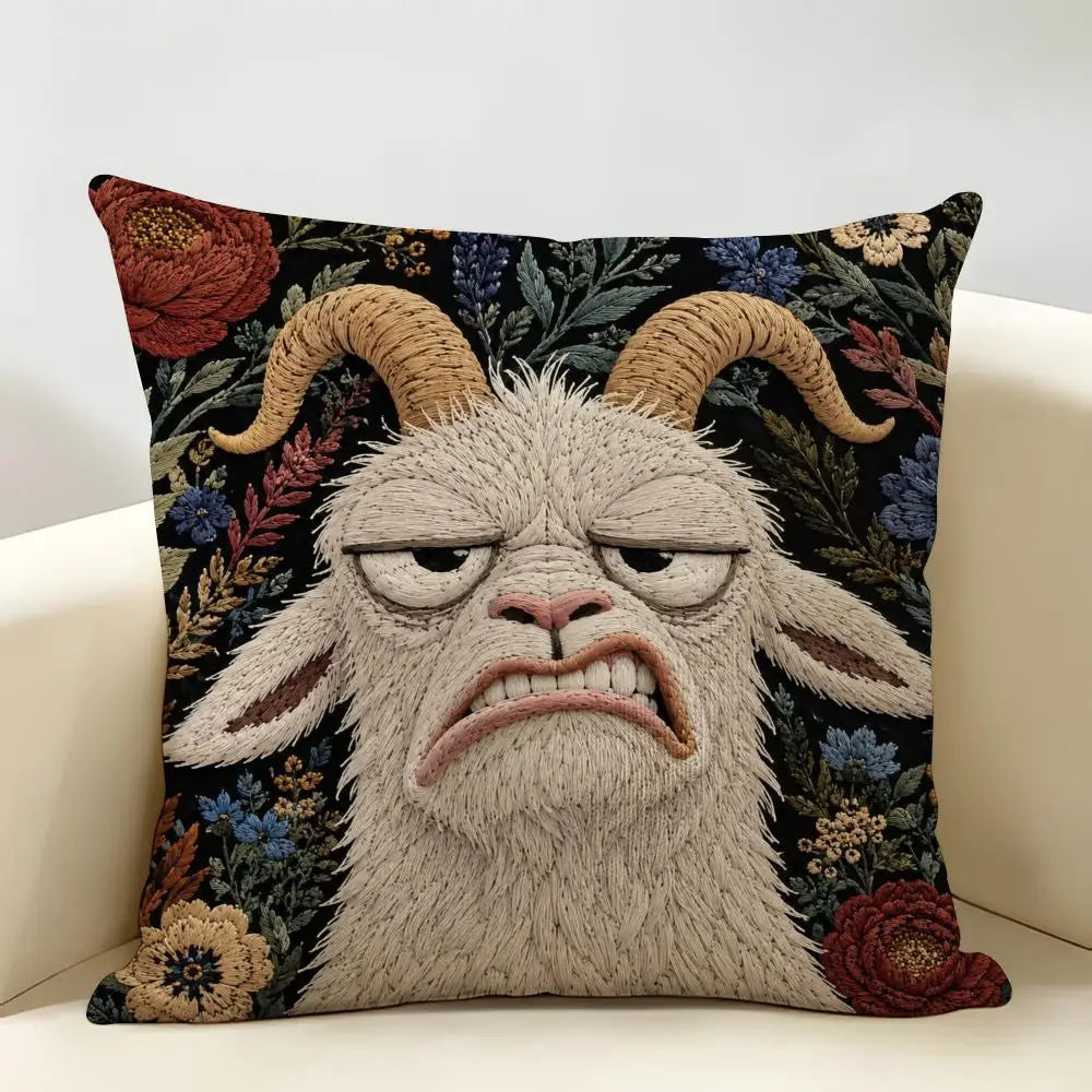A realistic embroidered depiction of a screaming goat face on a linen cushion cover.