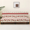 Red and white geometric print spandex slipcovers for sofa beds displayed on a light-colored wall.