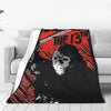 A black fleece throw blanket featuring a distressed red and white graphic of a skull and the text THE 13TH.