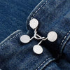 Silver metal button snaps attached to a dark blue denim fabric