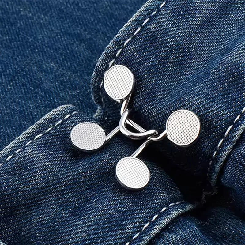 Silver metal button snaps attached to a dark blue denim fabric