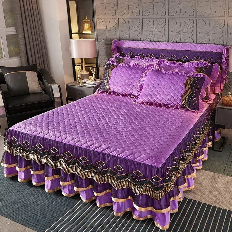 A purple velvet bed skirt with quilted bedding and decorative trim is displayed on a bed.