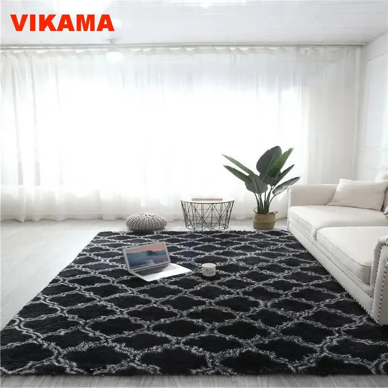 A black geometric plush area rug is displayed on a light floor in a bright room.