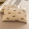A beige duvet cover featuring a repeating pattern of small orange and black striped dog silhouettes.