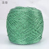A ball of metallic green silk yarn used for crocheting and knitting.