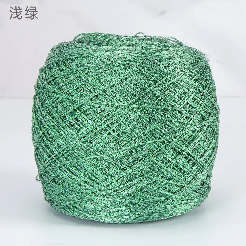 A ball of metallic green silk yarn used for crocheting and knitting.
