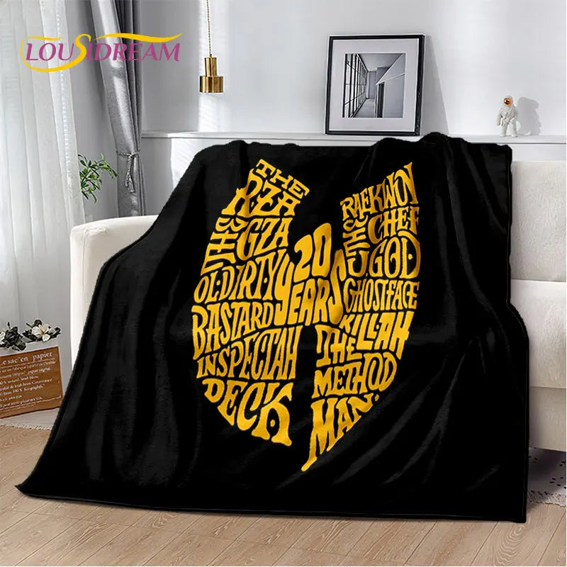 A black flannel throw blanket featuring a large yellow graphic text design on a white background.