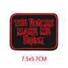 A black embroidered patch with red text that reads THE VOICES MAKE ME DRINK