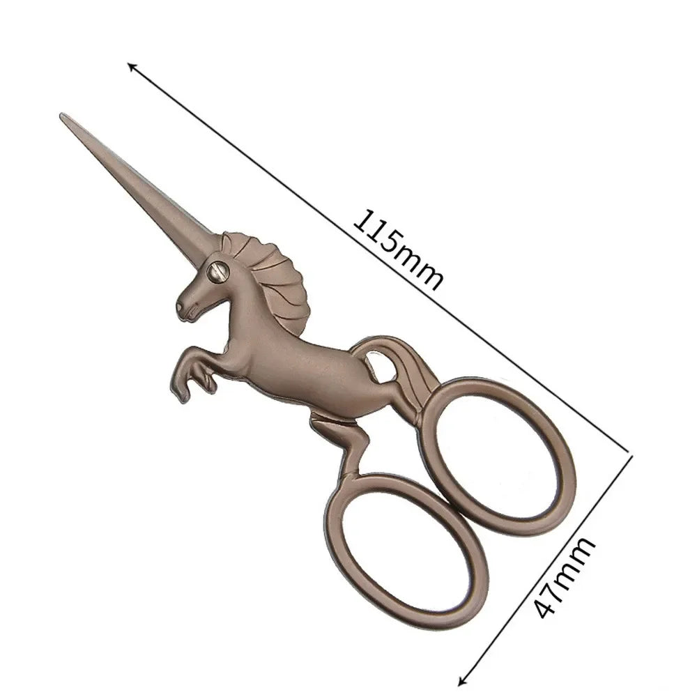 A pair of 3-color stainless steel unicorn sewing scissors shown with dimension lines.