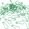 A pile of green safety bulb pins used for knitting and sewing.