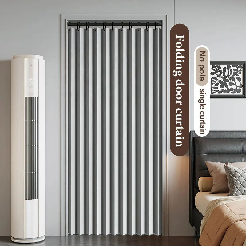 A vertical gray folding door curtain is shown next to a bedside table and a wall sign detailing its features.