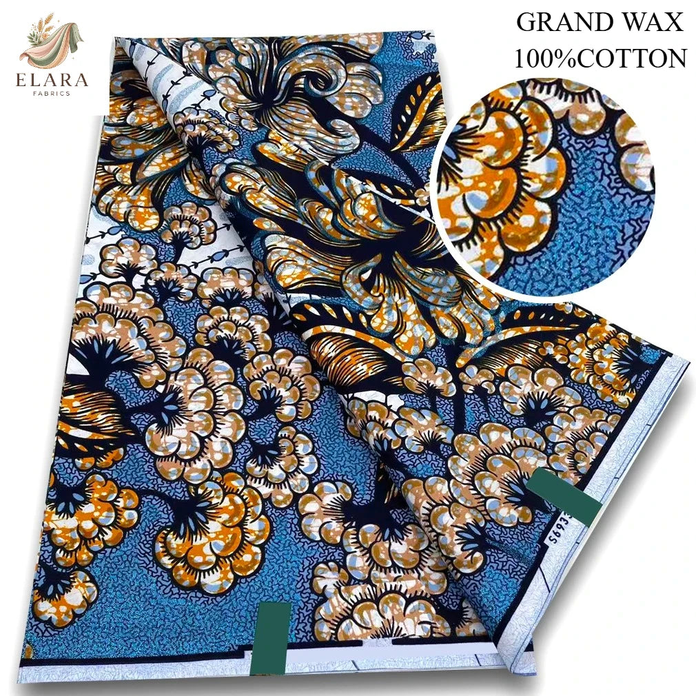 A bolt of brown and blue African wax print fabric with intricate floral patterns.