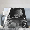 A black and white photo of a soccer player's profile, used as a design for a wool throw blanket.