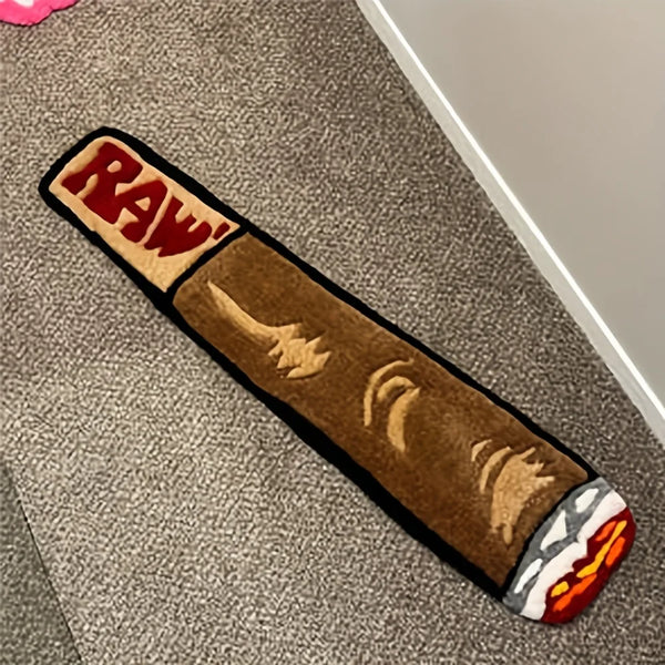 A brown decorative cigarette shaped floor mat with a red and white logo on the end.