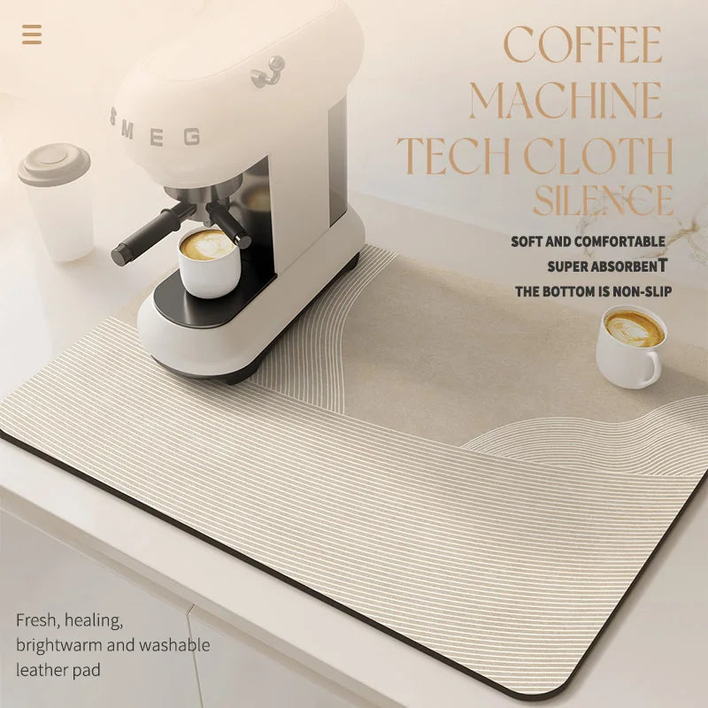 A white coffee machine is shown on a beige silicone mat with a coffee cup placed nearby.