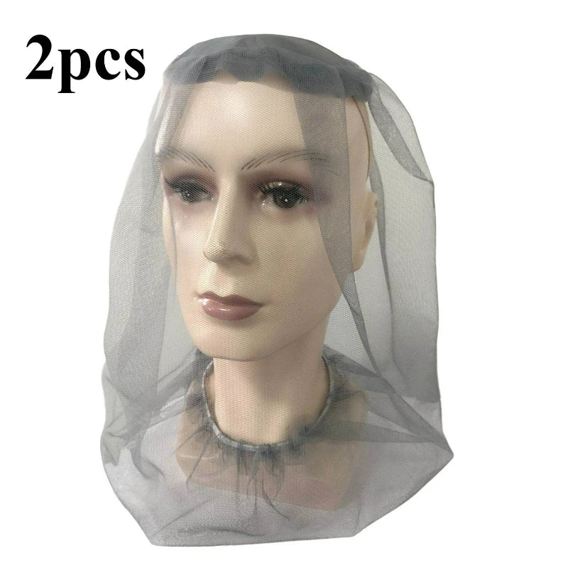 Two sheer grey mosquito nets with face masks displayed on a mannequin head.