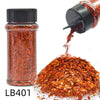 A glass jar of orange-red glitter mix is shown pouring onto a pile of loose, sparkling craft nail glitter.