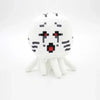 A white stuffed dragon plush toy with black markings and small white legs.