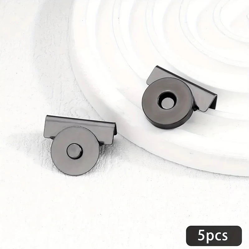 Five metal seamless magnetic closure buckles in a dark gray finish displayed on a white background.