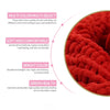Close-up view of bright red chunky velvet knitting yarn texture.