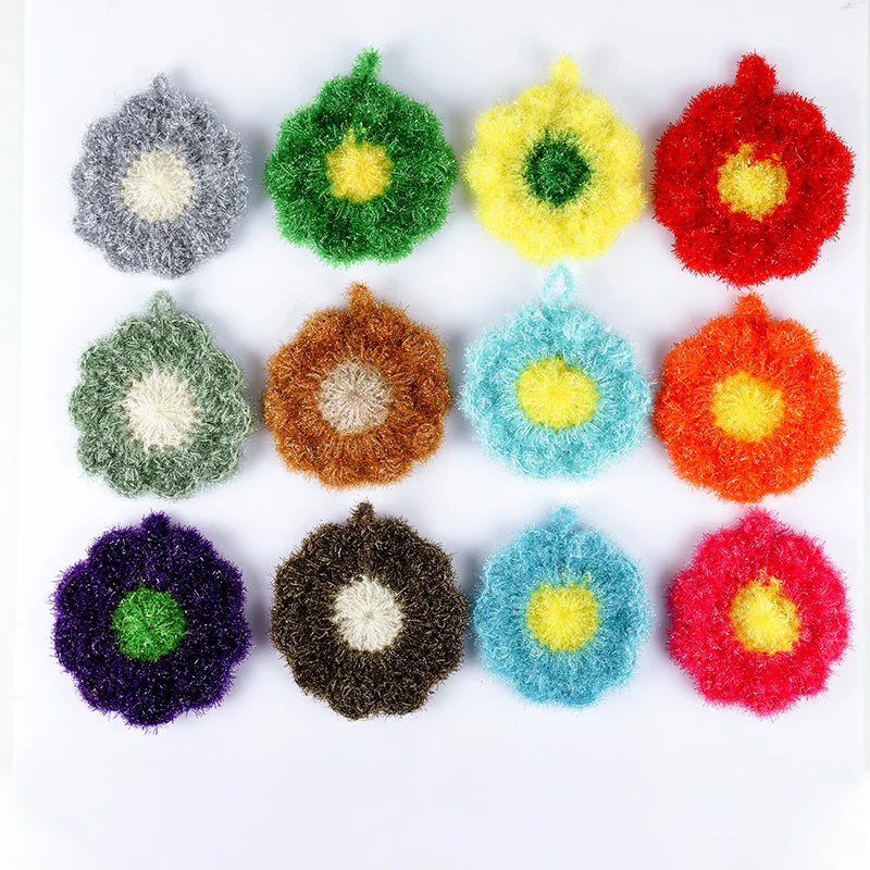 A collection of colorful flower-shaped kitchen dish scrubber sponges in various shades including green, yellow, red, purple, 