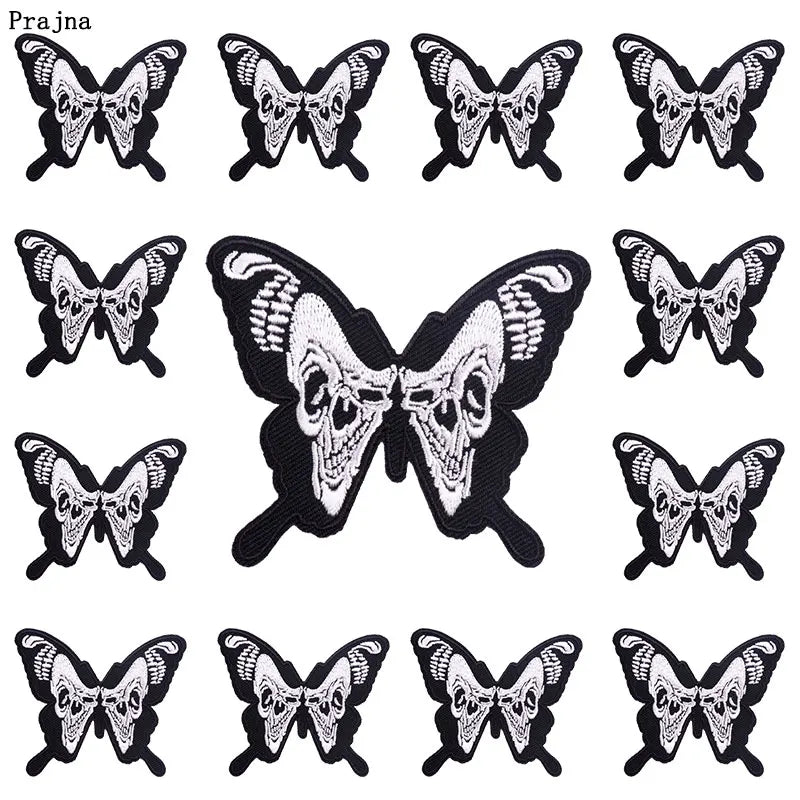 A collection of black and white skull-themed butterfly embroidery patches for clothing
