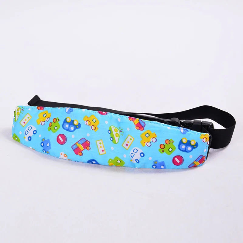 A colorful fabric head support for a baby car seat featuring various toy-themed shapes and colors.