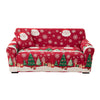 A festive red sofa cover featuring Christmas trees, snowflakes, and Santa faces.