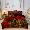 A bed featuring a luxury animal print bedding set with red roses and leopard print.