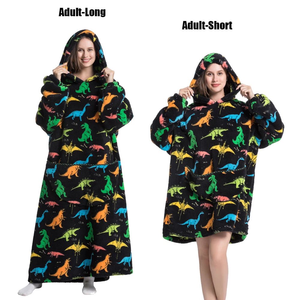 A woman models an adult-long plush fleece blanket hoodie with a colorful dinosaur print and an adult-short version.