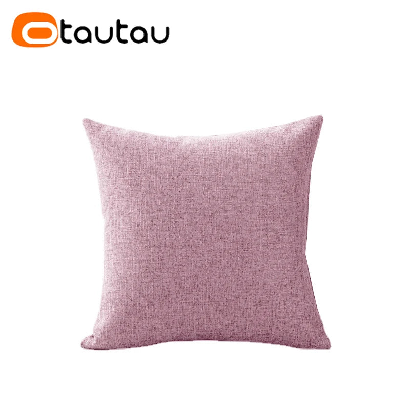 A square, dusty rose colored linen cushion cover with a button closure.