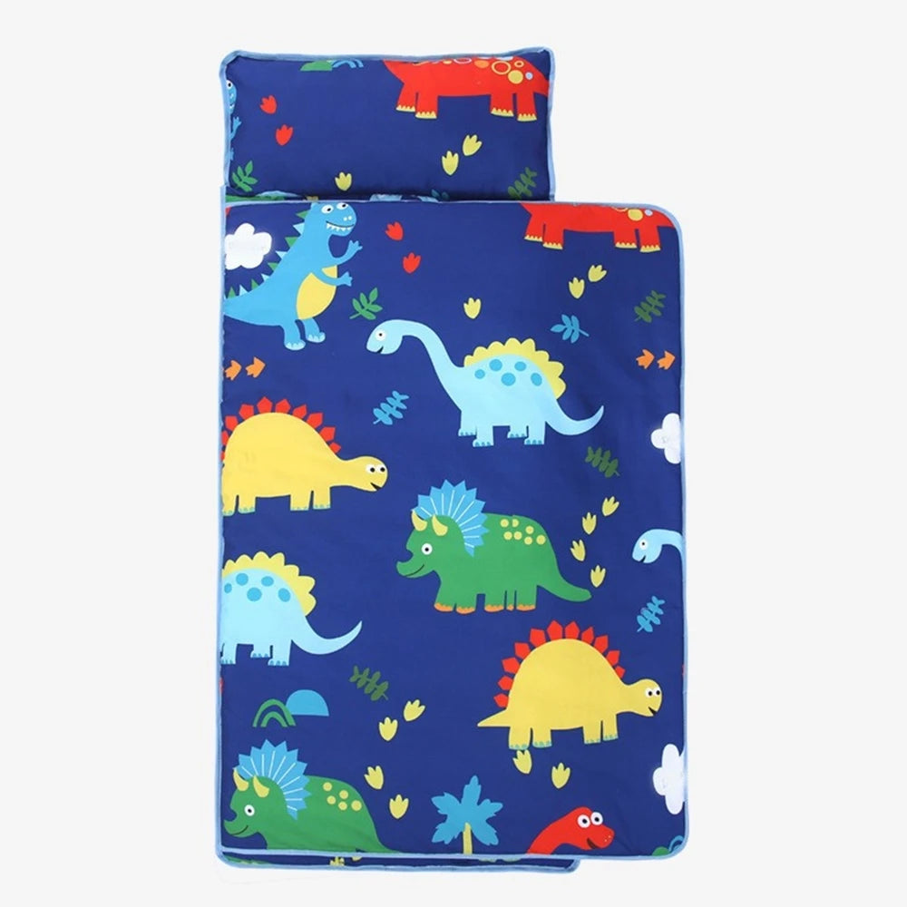 A set of toddler nap mats, including a pillow and fleece blanket, featuring colorful dinosaur patterns.